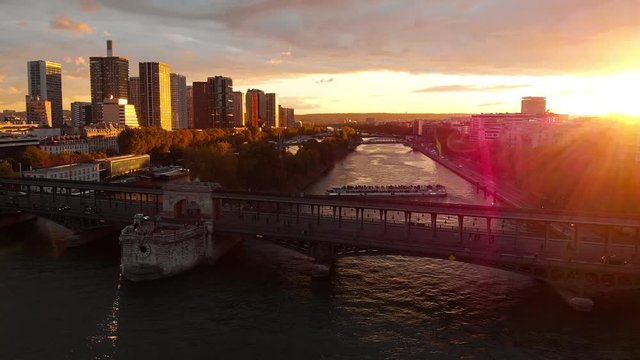 Aerial drone view of La Defense skyline and Seine River Paris sunset flare