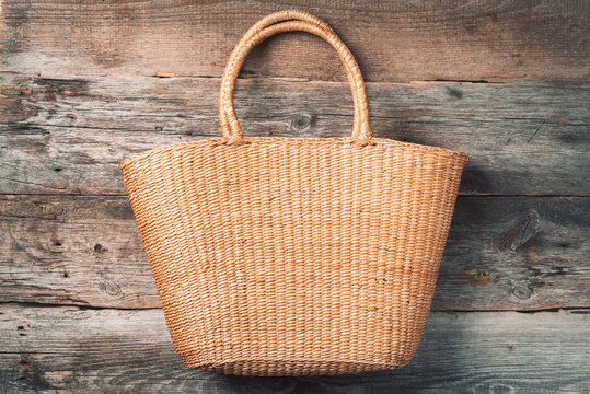 Handmade summer bag on wooden background. Top view. Fashionable stylish accessory. Natural, organic, eco friendly, zero waste, plastic free concept.