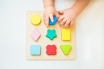 Hand holding wooden puzzle element. Concept of decision making process, logical thinking