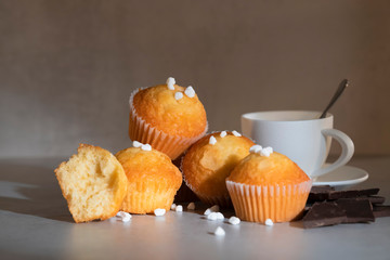 Muffins with pearl sugar, a cup of coffee and chocolate chunks