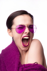 girl in a purple sweater, purple glasses with purple lipstick on her lips