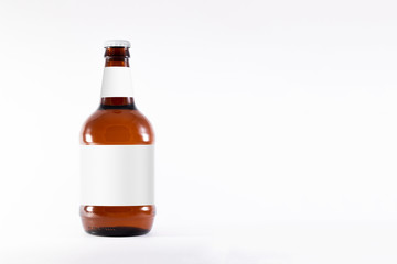 Full brown Beer Bottle Mock-up with blank label on white background.High resolution photo