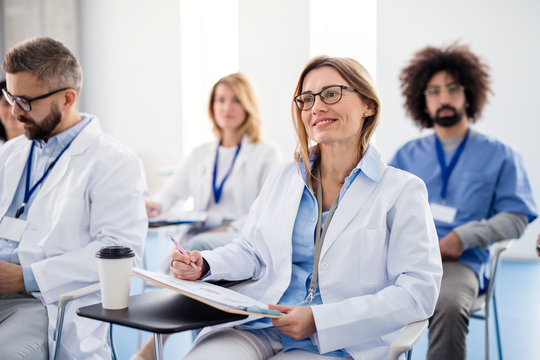 Group of doctors on conference, medical team sitting and listening.