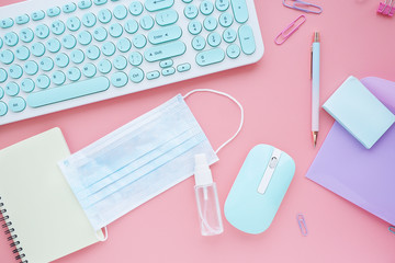 modern workplace with medical mask and spray with a disinfectant. New hygiene rules in connection with coronavirus..