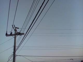 Closeup Eletricity line and electricity post wtih blue sky background from thailand