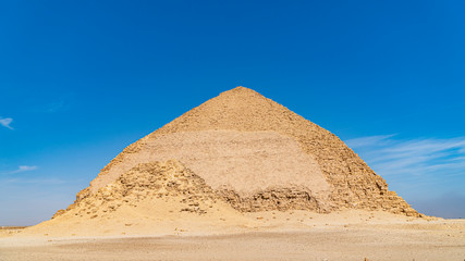Fototapeta na wymiar The Bent Pyramid is an ancient Egyptian pyramid located at the royal necropolis of Dahshur, approximately 40 kilometres south of Cairo, built under the Old Kingdom Pharaoh Sneferu. Egypt