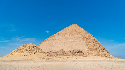 Fototapeta na wymiar The Bent Pyramid is an ancient Egyptian pyramid located at the royal necropolis of Dahshur, approximately 40 kilometres south of Cairo, built under the Old Kingdom Pharaoh Sneferu. Egypt