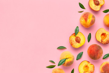 Summer fruit background. Flat lay composition with peaches. Ripe juicy peaches with green leaves on...