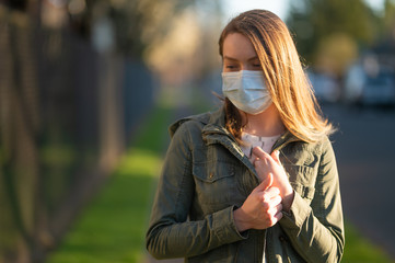 Coronavirus, masked girl on an empty street in USA. The title is about an outbreak of a coronavirus