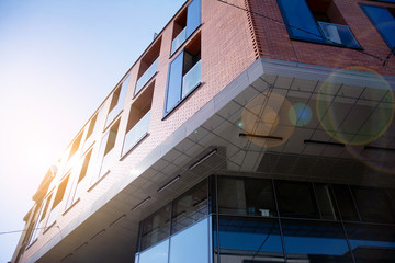 Modern apartment building exterior concept. Sunshine sun flare.  