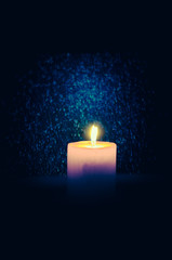 burial concept with burning candle against black background