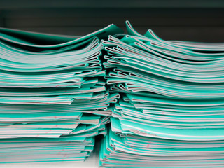 School notebooks lie in a careless pile on a shelf in the store.