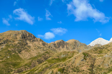 A golden colored mountains range at the Austrian-Italian border. The autumn vibes in Alps, nature getting ready for hibernation. Sharp, rocky Alpine peaks in the back. Serenity and solitude