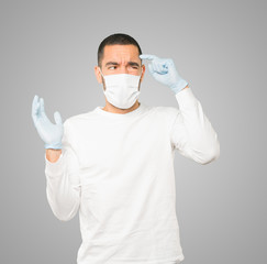 Coronavirus.Young man doing concepts and wearing mask and protective gloves