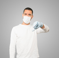 Coronavirus.Young man doing concepts and wearing mask and protective gloves
