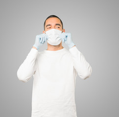 Coronavirus.Young man doing concepts and wearing mask and protective gloves