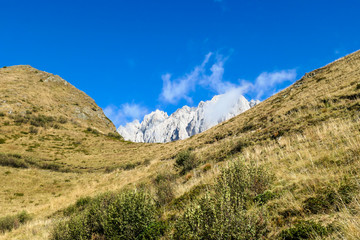 A golden colored mountains range at the Austrian-Italian border. The autumn vibes in Alps, nature getting ready for hibernation. Sharp, rocky Alpine peaks in the back. Serenity and solitude