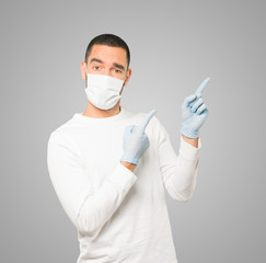 Coronavirus.Young man doing concepts and wearing mask and protective gloves