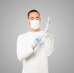 Fototapeta premium Coronavirus.Young man doing concepts and wearing mask and protective gloves
