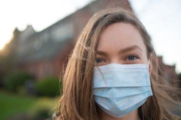 On the street, a girl in a place, protected from coronavirus. A virus outbreak, danger, and quarantine. Photo for news and media