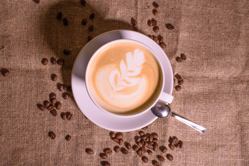 Tasty and fragrant cappuccino on the background of the canvas.