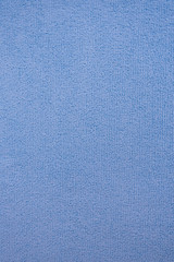 Fabric texture with a high content of microfiber. Blue background, vertical.