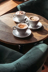 Cocoa in large white cup on table in cafe. Cocoa with marshmallows, peppers and cinnamon.