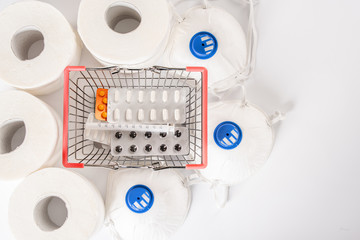 Shopping basket with medicines, tablets and anti-virus mask. Stocks of dry food and toilet paper during the covid-19 coronovirus epidemic