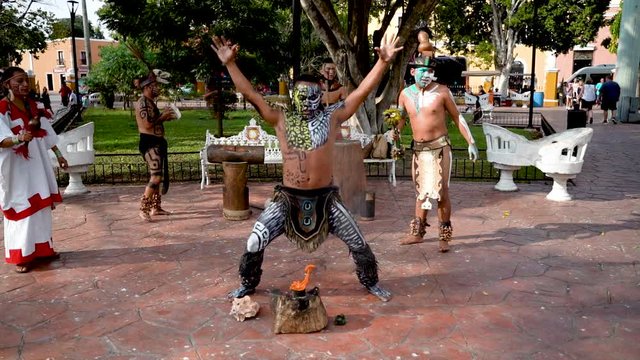 Slow motion Mayan and Aztec dancers performing a sacred dance in a park outside in Valladolid, Yucatan, Mexico.