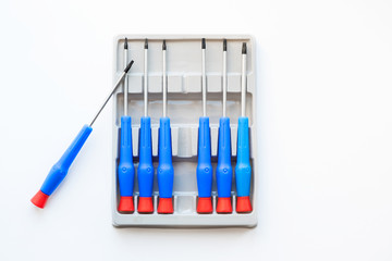 Set of blue screwdrivers in a box, on a white background.