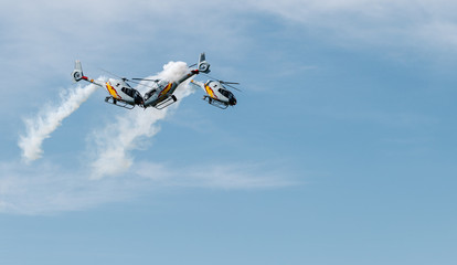 Helicopters face to face doing acrobatic flights about to have an accident
