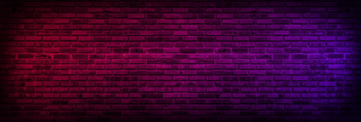 Panorama Neon light on brick walls that are not plastered background and texture. Lighting effect...