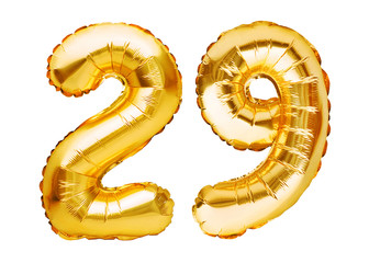 Number 29 twenty nine made of golden inflatable balloons isolated on white. Helium balloons, gold foil numbers. Party decoration, anniversary sign for holidays, celebration, birthday, carnival - obrazy, fototapety, plakaty
