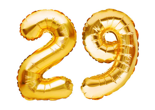 Number 29 twenty nine made of golden inflatable balloons isolated on white. Helium balloons, gold foil numbers. Party decoration, anniversary sign for holidays, celebration, birthday, carnival