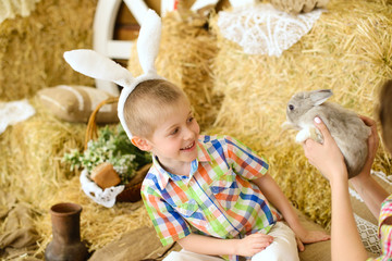 mother holds in hands little boy fluffy gray rabbit