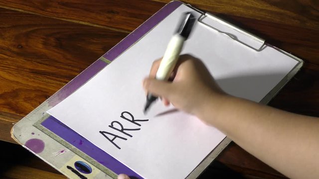 Arriving soon text message being written by hand and fingers.