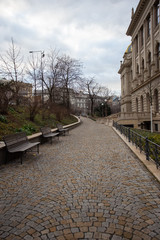 Cobbled pathway and two benches on one side of it