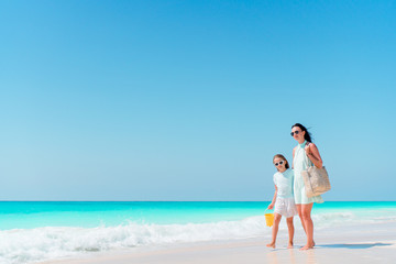 Beautiful mother and daughter on the beach