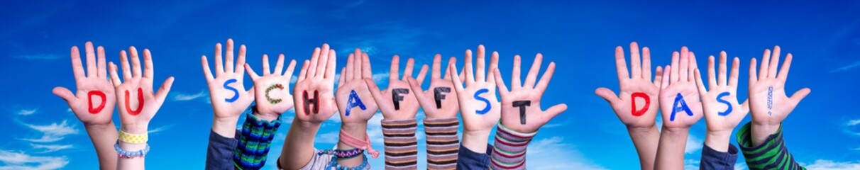 Children Hands Building Colorful German Word Du Schaffst Das Means You Can Do It. Blue Sky As...