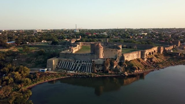 aerial View of fortress at sunset over the sea, aerial view of Akerman Fortress at sunset, Flying on drone over ancient fortress Akkerman which is on the bank of the Dniester estuary in Bilhorod