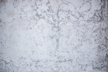 texture of old peeling plaster on a white wall