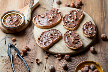 Sandwiches with chocolate cream on wood.