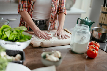 Obraz na płótnie Canvas Woman in kitchen. Beautiful lady baking bread