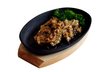 Liver with onion in creamy sauce in cast iron pan