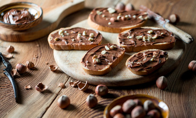 Sandwiches with chocolate cream on wood.