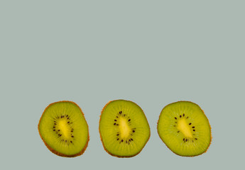 Sliced kiwi isolated on blue background. Copyspace for text.