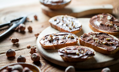 Sandwiches with chocolate cream on wood.