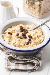 Bowl of oatmeal porridge with raisins