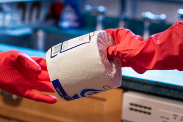 Latex gloved hand shares a roll of toilet paper © Mark