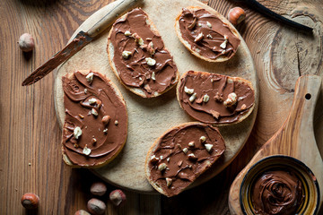 Sandwiches with chocolate cream on wood.